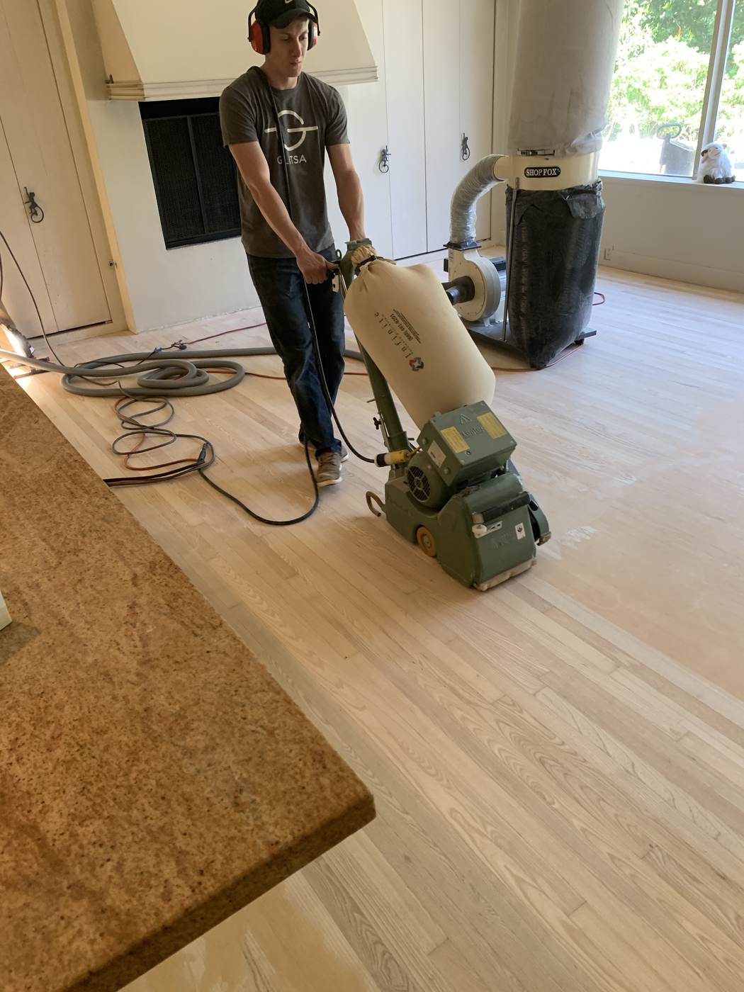 Oak floor sanded back to bare wood before the new finish.