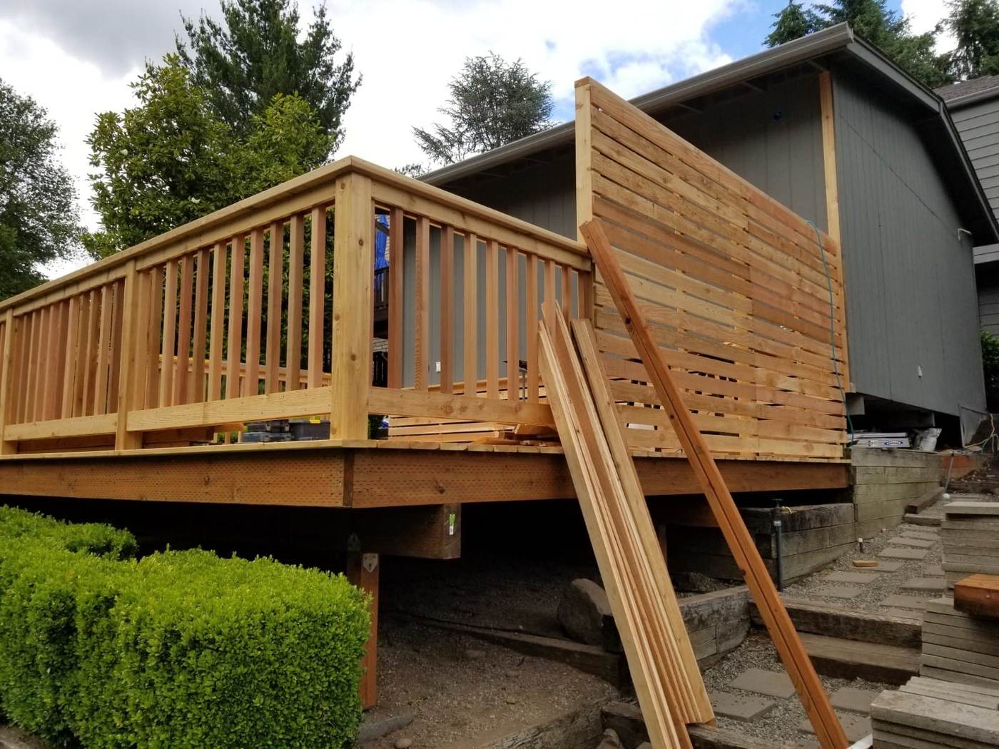 New deck framing, railing and privacy screen going up.