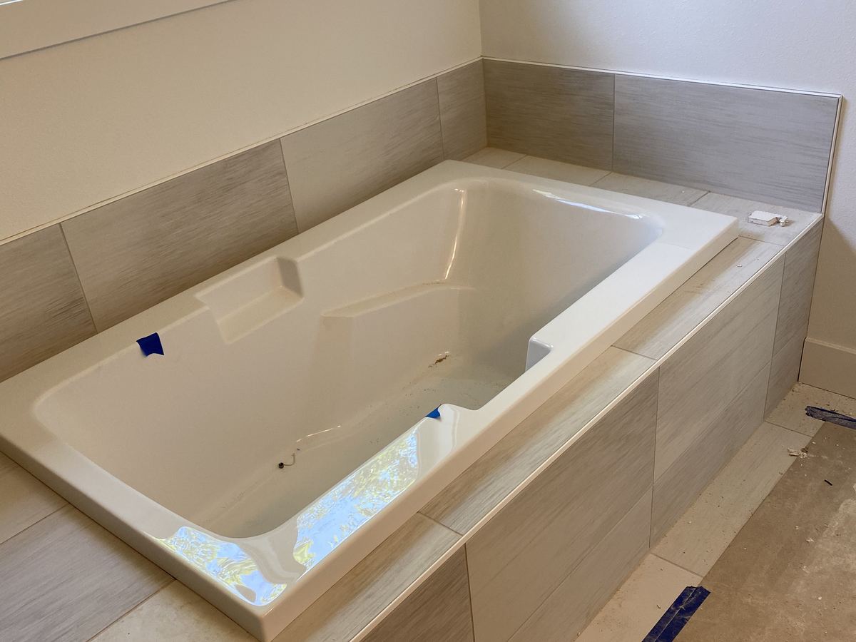 Soaking Tub Surround. Drop-in tub set in a large format tile deck and wall.