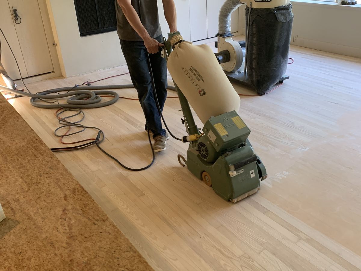 Floor Refinishing. Oak floor sanded back to bare wood before the new finish.
