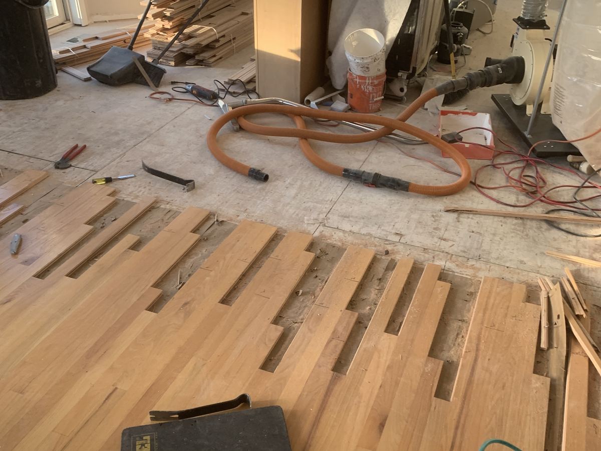 Hardwood Repair. New boards woven into the old floor before sanding.
